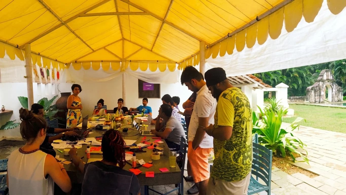 Participants gather around a table for a BHX workshop.
