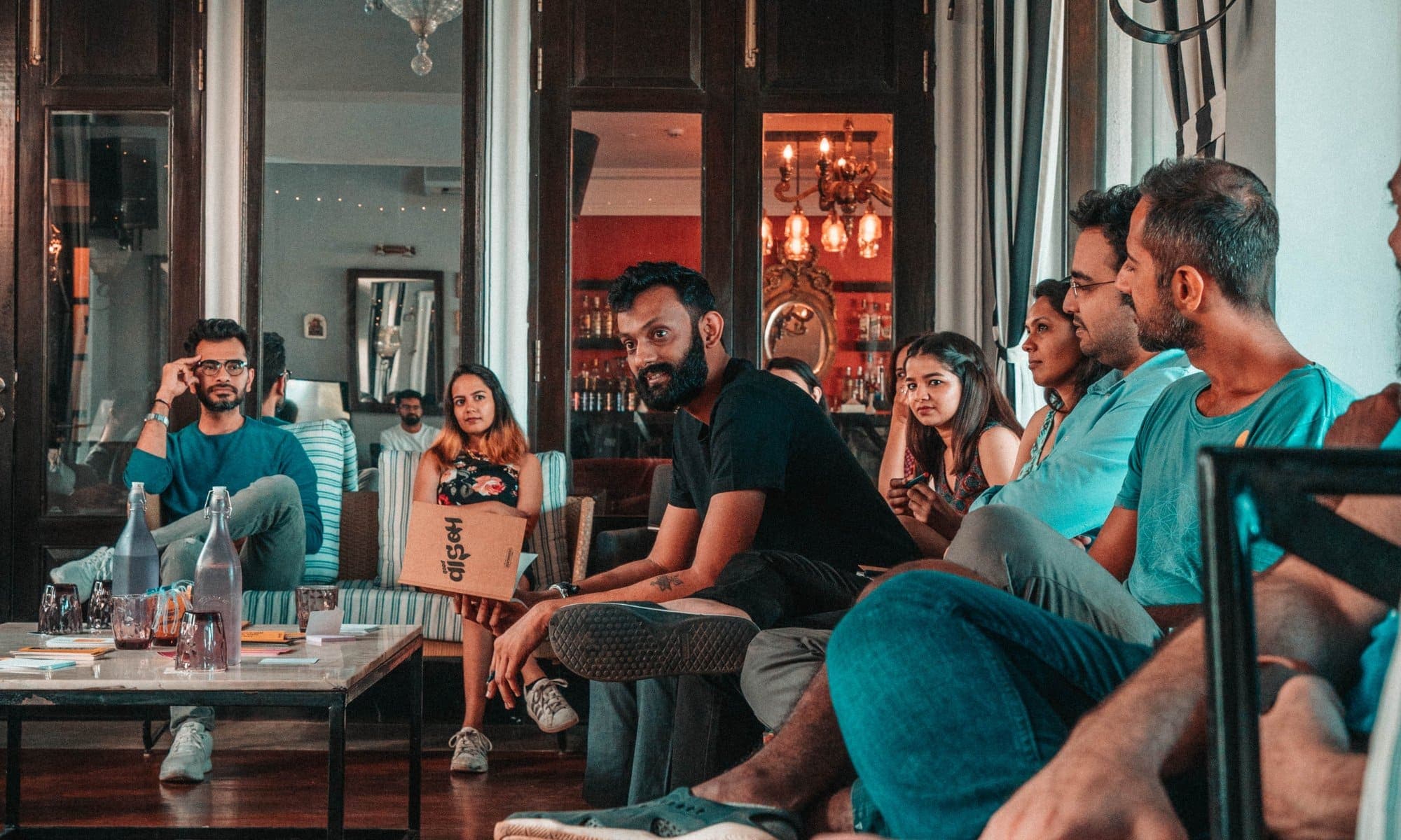 Guests sitting together in conversation at an Experience Co. gathering.